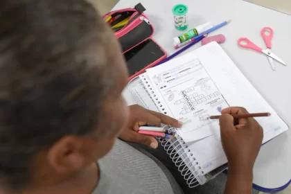 Uma mulher escreve num caderno. Autora discute conceito de inteligência